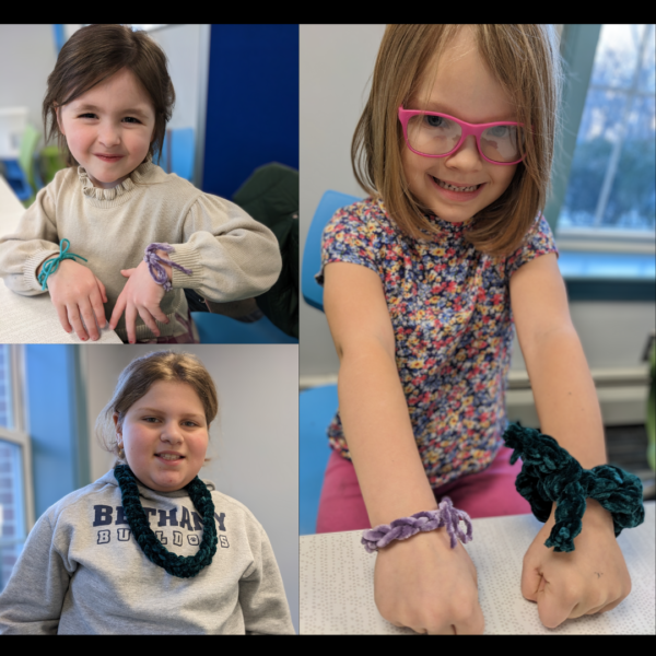 Children showing off their crochet bracelets and necklaces