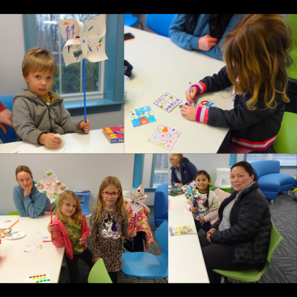 Children with their parents decorating small blank puzzles and paper pinwheels